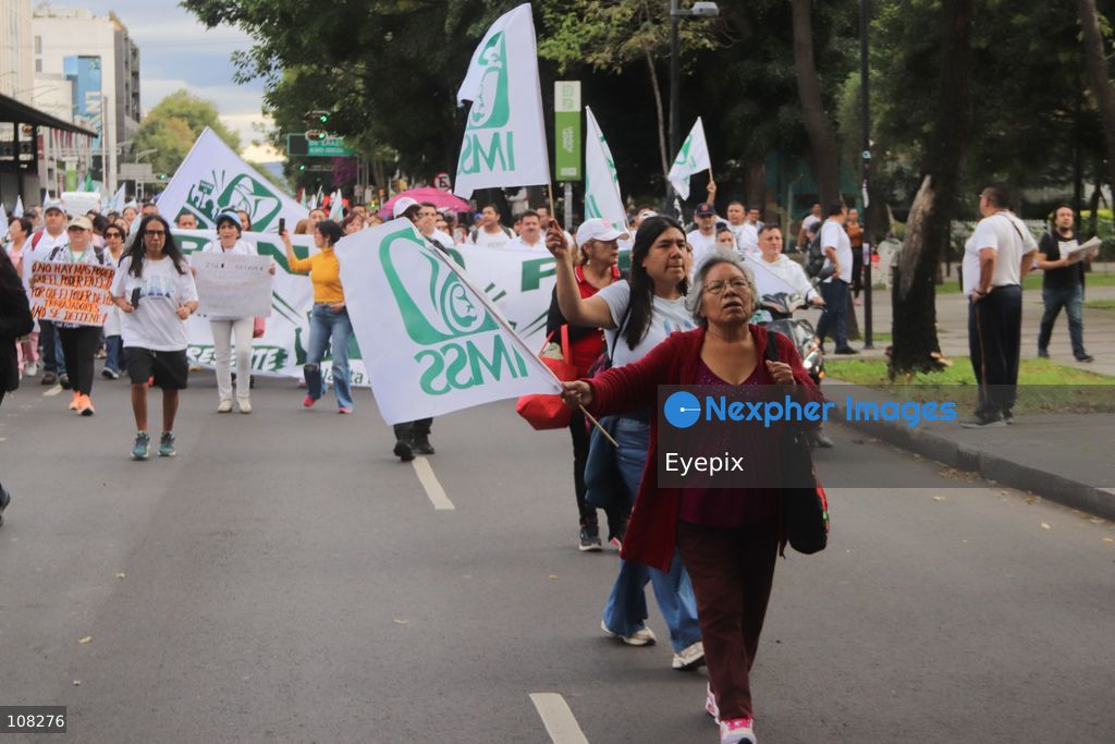 Healthcare workers belonging to the Mexican Social Security Institute (IMSS) protest to demand a direct pay raise based on the pay scale, a comprehensive supply of medical equipment and supplies, and the resignation of the General Secretary of the National Union of Social Security Workers (SNTSS). on October 21, 2026 in Mexico City, Mexico. (Photo by Carlos Santiago / Eyepix Group/Eyepix via Nexpher Images)
