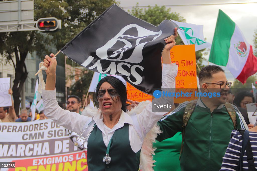 Healthcare workers belonging to the Mexican Social Security Institute (IMSS) protest to demand a direct pay raise based on the pay scale, a comprehensive supply of medical equipment and supplies, and the resignation of the General Secretary of the National Union of Social Security Workers (SNTSS). on October 21, 2026 in Mexico City, Mexico. (Photo by Carlos Santiago / Eyepix Group/Eyepix via Nexpher Images)