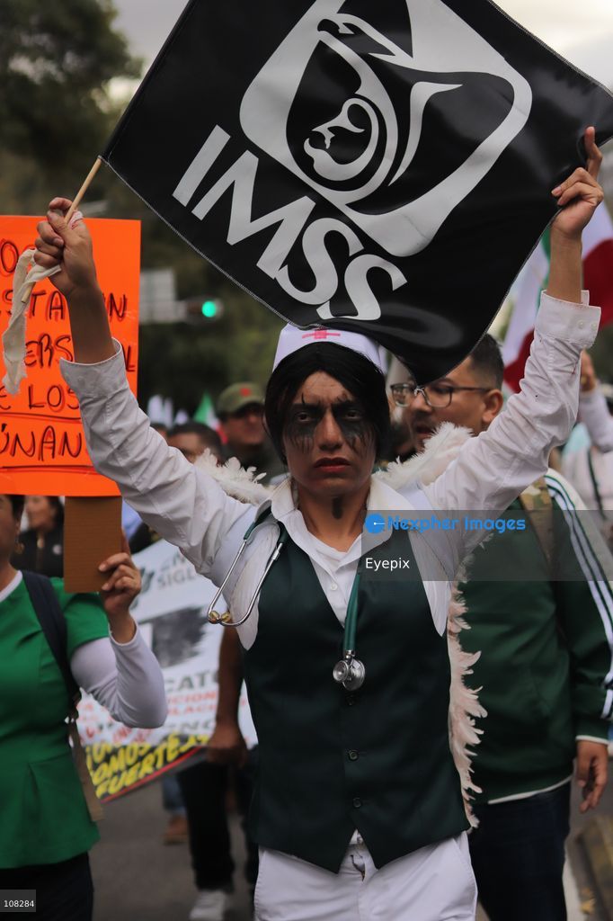 Healthcare workers belonging to the Mexican Social Security Institute (IMSS) protest to demand a direct pay raise based on the pay scale, a comprehensive supply of medical equipment and supplies, and the resignation of the General Secretary of the National Union of Social Security Workers (SNTSS). on October 21, 2026 in Mexico City, Mexico. (Photo by Carlos Santiago / Eyepix Group/Eyepix via Nexpher Images)
