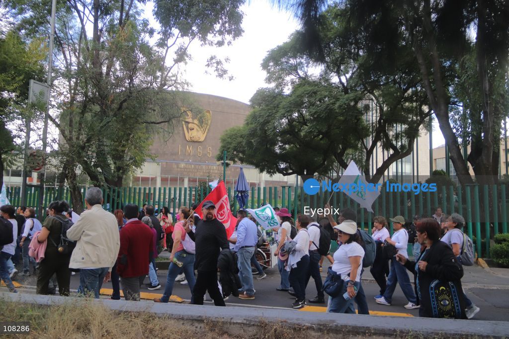 Healthcare workers belonging to the Mexican Social Security Institute (IMSS) protest to demand a direct pay raise based on the pay scale, a comprehensive supply of medical equipment and supplies, and the resignation of the General Secretary of the National Union of Social Security Workers (SNTSS). on October 21, 2026 in Mexico City, Mexico. (Photo by Carlos Santiago / Eyepix Group/Eyepix via Nexpher Images)