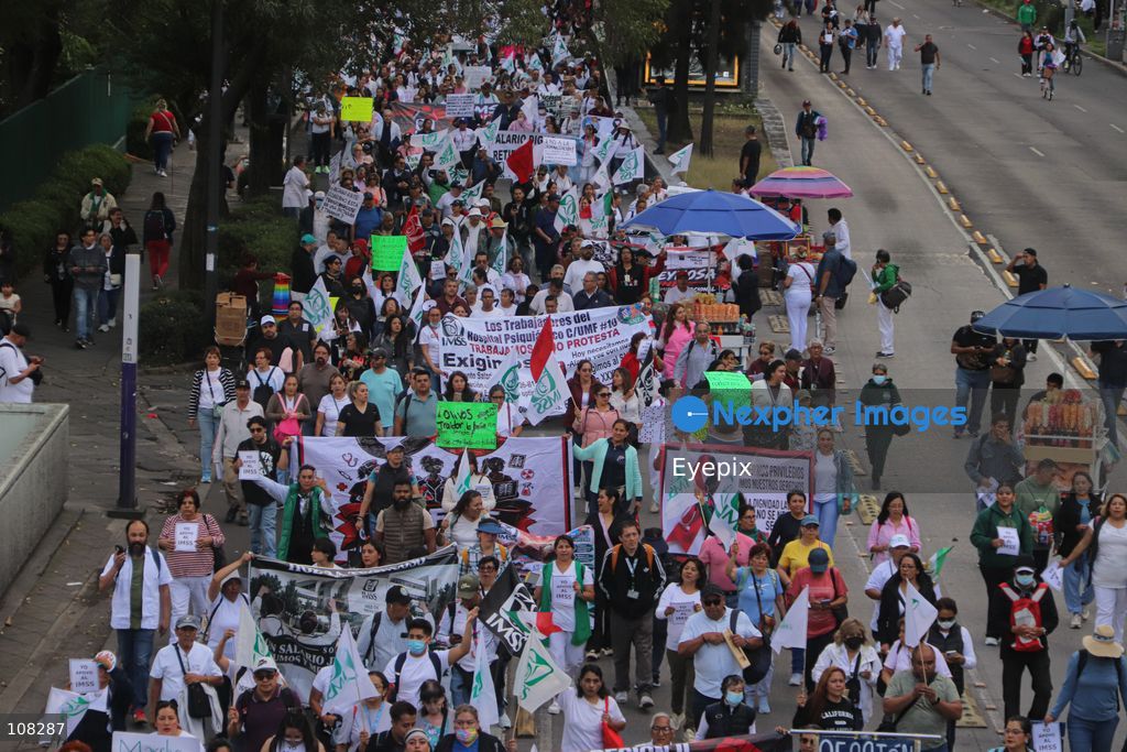 Healthcare workers belonging to the Mexican Social Security Institute (IMSS) protest to demand a direct pay raise based on the pay scale, a comprehensive supply of medical equipment and supplies, and the resignation of the General Secretary of the National Union of Social Security Workers (SNTSS). on October 21, 2026 in Mexico City, Mexico. (Photo by Carlos Santiago / Eyepix Group/Eyepix via Nexpher Images)