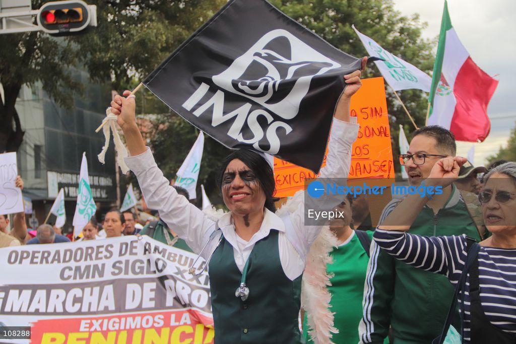 Healthcare workers belonging to the Mexican Social Security Institute (IMSS) protest to demand a direct pay raise based on the pay scale, a comprehensive supply of medical equipment and supplies, and the resignation of the General Secretary of the National Union of Social Security Workers (SNTSS). on October 21, 2026 in Mexico City, Mexico. (Photo by Carlos Santiago / Eyepix Group/Eyepix via Nexpher Images)