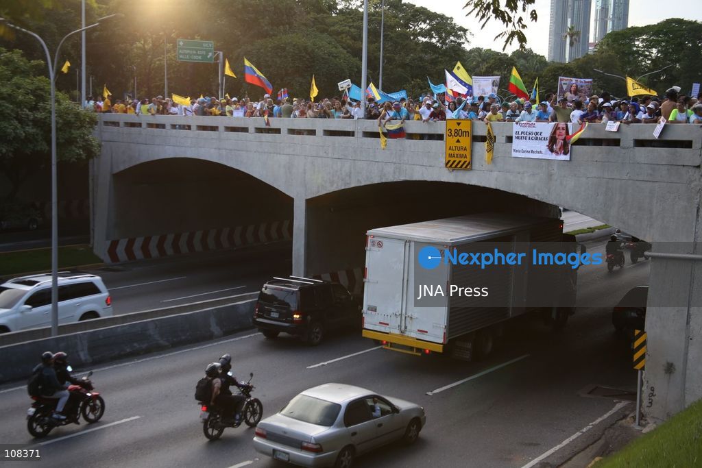CARACAS, VENEZUELA, OCTOBER 22, 2026: Opposition supporters demonstrate in Caracas to demand a timetable for presidential elections and the safe return of opposition leader Maria Corina Machado to Venezuela. The rally forms part of nationwide mobilisations called by her Vente Venezuela movement, also demanding the release of political prisoners. (Photo by Moisés Quintero/JNA Press via Nexpher Images)
