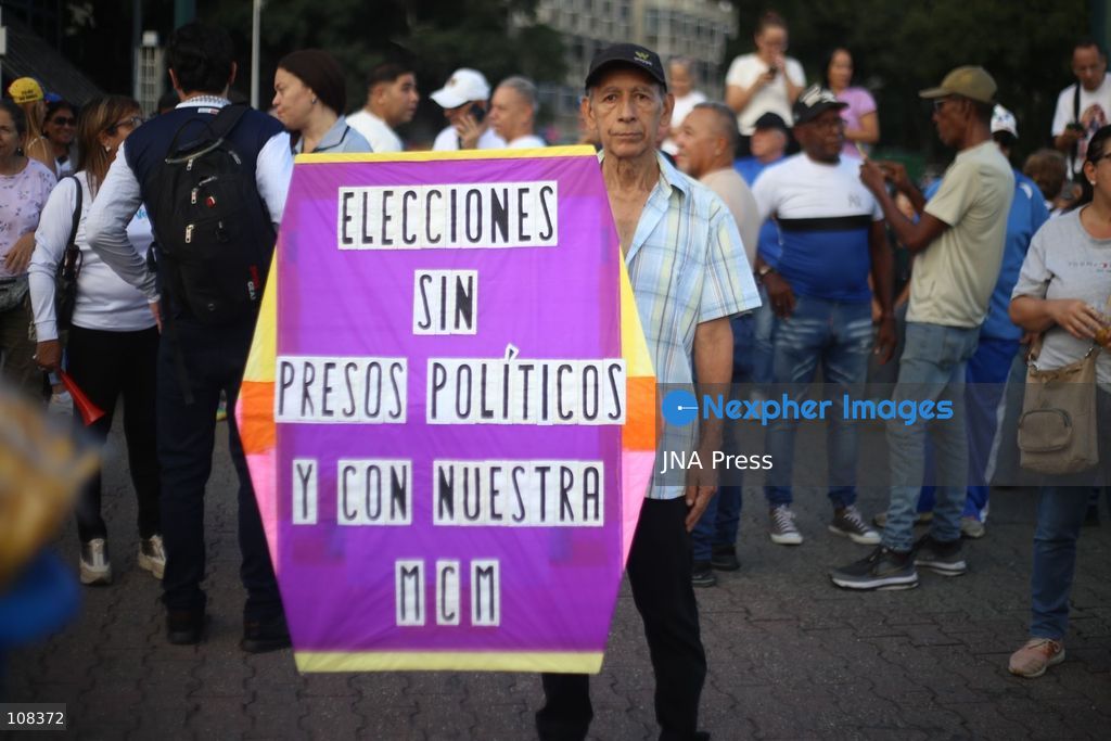 CARACAS, VENEZUELA, OCTOBER 22, 2026: Opposition supporters demonstrate in Caracas to demand a timetable for presidential elections and the safe return of opposition leader Maria Corina Machado to Venezuela. The rally forms part of nationwide mobilisations called by her Vente Venezuela movement, also demanding the release of political prisoners. (Photo by Moisés Quintero/JNA Press via Nexpher Images)