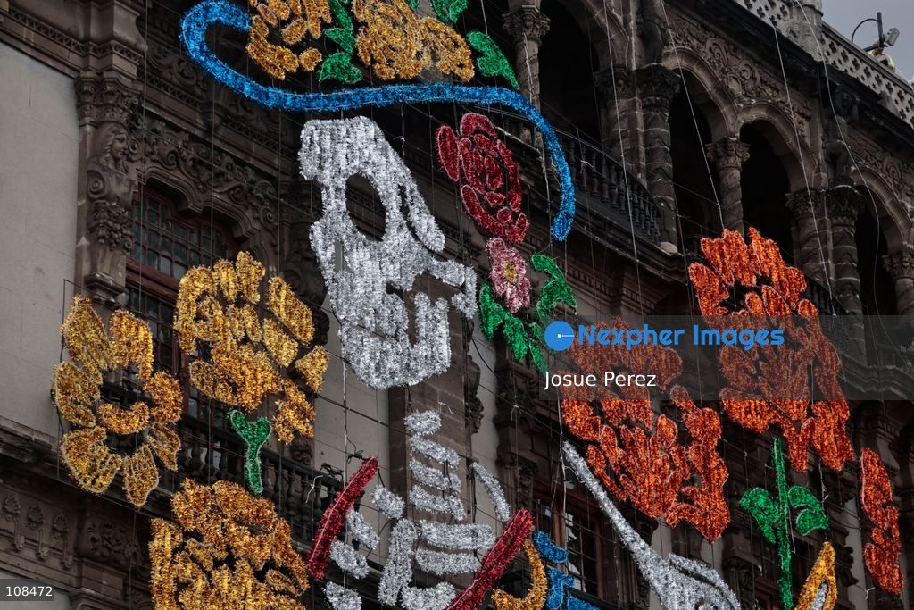 A worker is lifted in a crane to install and secure the lighting for the Day of the Dead on October 22, 2026, in Mexico City, Mexico. Construction crews working for the Mexico City government have begun assembling and installing the structures that will illuminate the buildings surrounding the city’s Zócalo. Using cranes, cables, and various framework components, they are preparing everything for the unveiling of the Monumental Ofrenda (altar), which will feature the world’s tallest Catrina, so that both locals and tourists can enjoy the start of the Day of the Dead celebrations in Mexico. (Photo by Josue Perez/Nexpher Images)