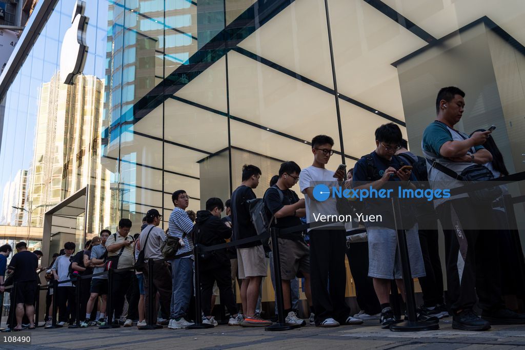 People lining up outside an Apple Store to pick up their iPhone Duo on October 22, 2026 in Hong Kong. The iPhone DUO is Apple INC.’s first foldable phone, today is the first day the new iPhone DUO is available to the public. (Photo by Vernon Yuen/Nexpher Images)