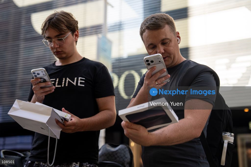 iPhone resellers holding boxes of iPhone Duo outside an Apple Store on October 22, 2026 in Hong Kong. The iPhone DUO is Apple INC.’s first foldable phone, today is the first day the new iPhone DUO is available to the public. (Photo by Vernon Yuen/Nexpher Images)