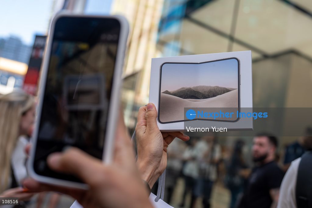 A customer taking a photo of a iPhone Duo box outside an Apple Store on October 22, 2026 in Hong Kong. The iPhone DUO is Apple INC.’s first foldable phone, today is the first day the new iPhone DUO is available to the public. (Photo by Vernon Yuen/Nexpher Images)