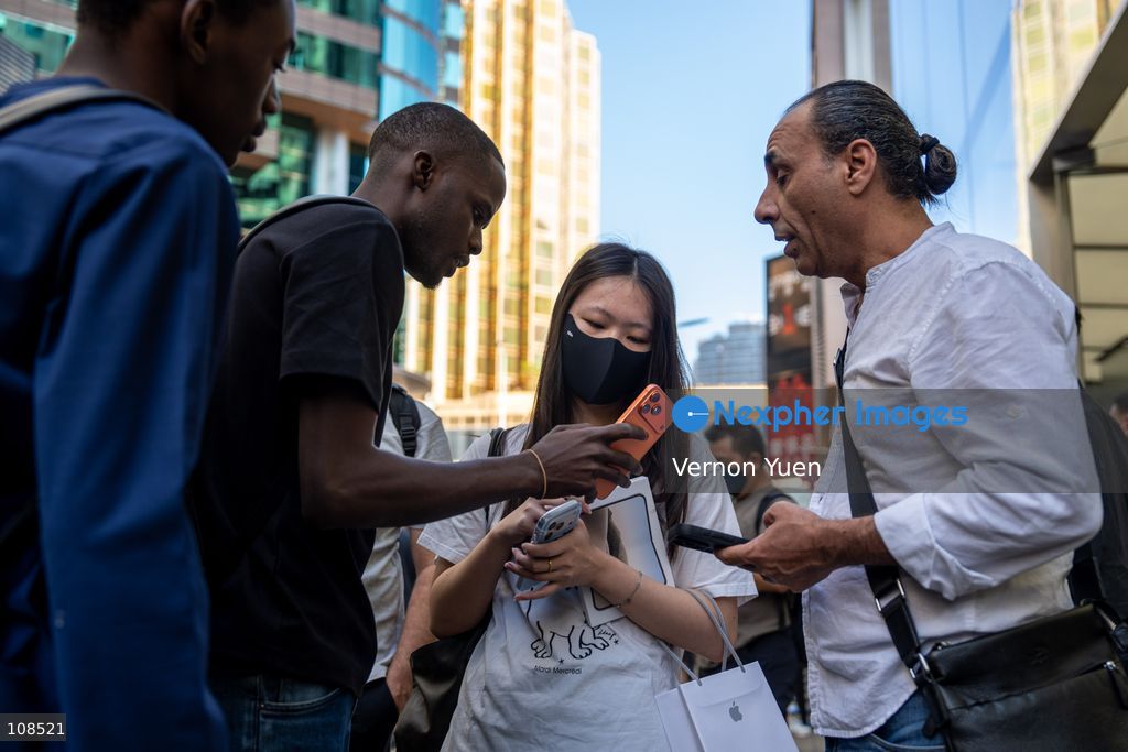 An iPhone reseller trying to buy an iPhone duo from a woman outside an Apple Store on October 22, 2026 in Hong Kong. The iPhone DUO is Apple INC.’s first foldable phone, today is the first day the new iPhone DUO is available to the public. (Photo by Vernon Yuen/Nexpher Images)