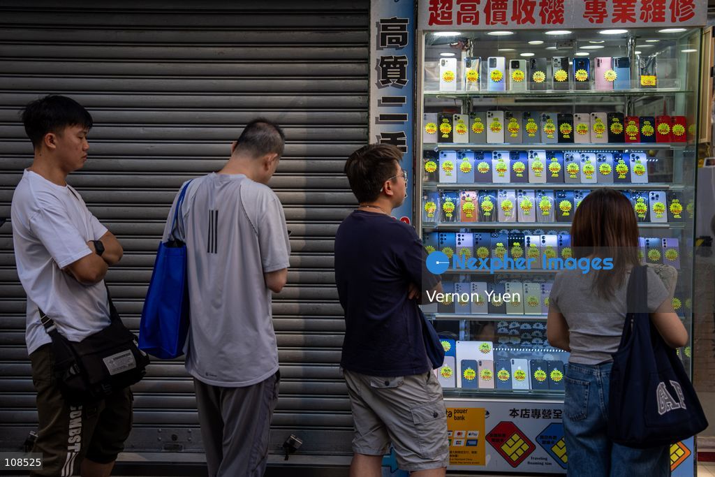 People selling iPhones Duo lining up outside Sin Tat Plaza, a popular iPhone location for phone resellers on October 22, 2026 in Hong Kong. The iPhone DUO is Apple INC.’s first foldable phone, today is the first day the new iPhone DUO is available to the public. (Photo by Vernon Yuen/Nexpher Images)