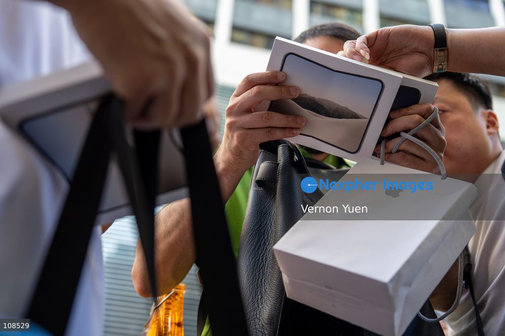 iPhone resellers holding boxes of iPhone Duo outside an Apple Store on October 22, 2026 in Hong Kong. The iPhone DUO is Apple INC.’s first foldable phone, today is the first day the new iPhone DUO is available to the public. (Photo by Vernon Yuen/Nexpher Images)