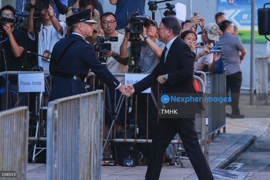 Hong Kong Chief Secretary for Administration Chan Kwok-ki is greeted by Commissioner of Police Joe Chow Yat-ming upon arrival at the Universal Funeral Parlour for the funeral of late police officer Chu Chun-kwok in Hung Hom, Hong Kong, on October 23, 2026. (Photo by Zulu Lo/TMHK via Nexpher Images)