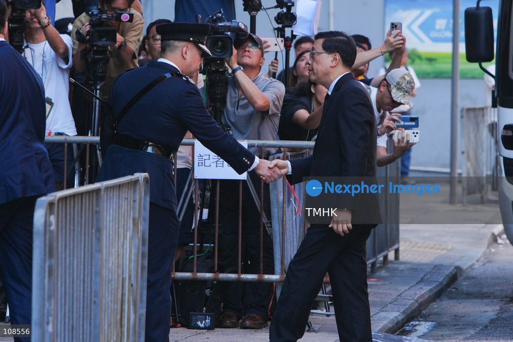Hong Kong Chief Executive John Lee Ka-chiu is greeted by Commissioner of Police Joe Chow Yat-ming upon arrival at the Universal Funeral Parlour for the funeral of late police officer Chu Chun-kwok in Hung Hom, Hong Kong, on October 23, 2026. (Photo by Zulu Lo/TMHK via Nexpher Images)