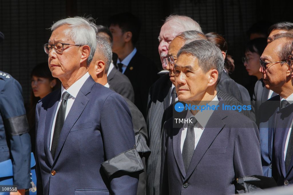 Former Hong Kong police commissioners Lee Ming-kwei and Tang King-shing wait outside the Universal Funeral Parlour ahead of the departure of the hearse following the funeral of late police officer Chu Chun-kwok in Hung Hom, Hong Kong, on October 23, 2026. (Photo by Zulu Lo/TMHK via Nexpher Images)