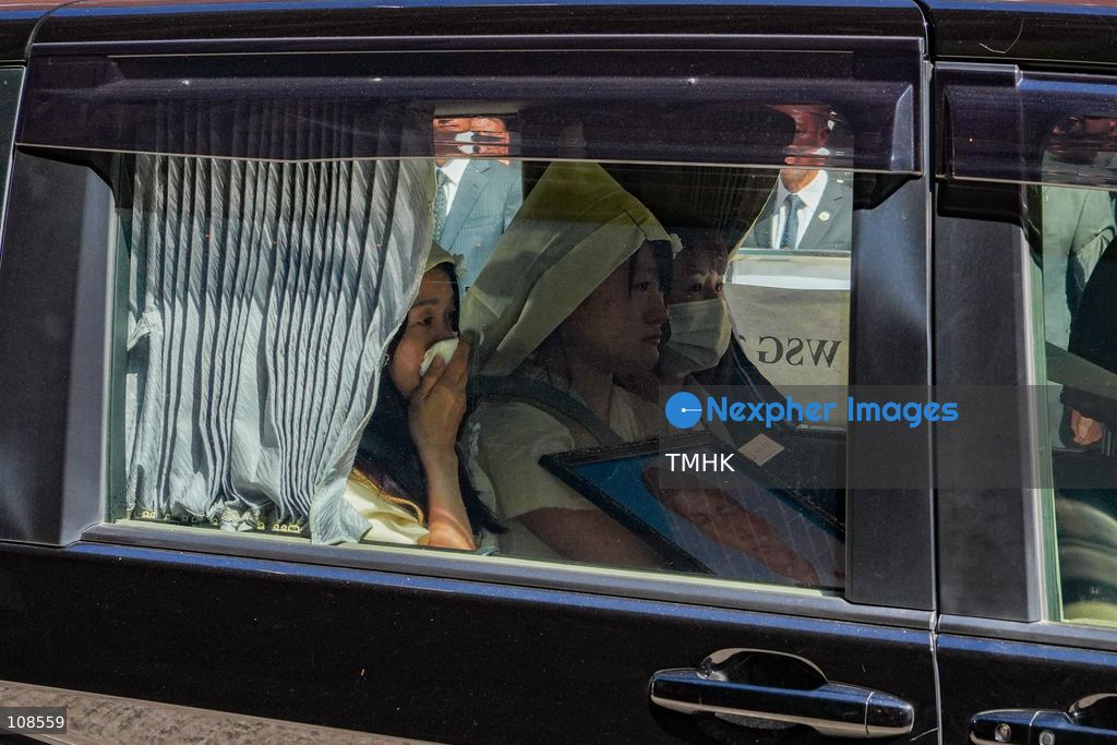 Family members leave the Universal Funeral Parlour in a private car following the hearse after the funeral of late police officer Chu Chun-kwok in Hung Hom, Hong Kong, on October 23, 2026. (Photo by Zulu Lo/TMHK via Nexpher Images)