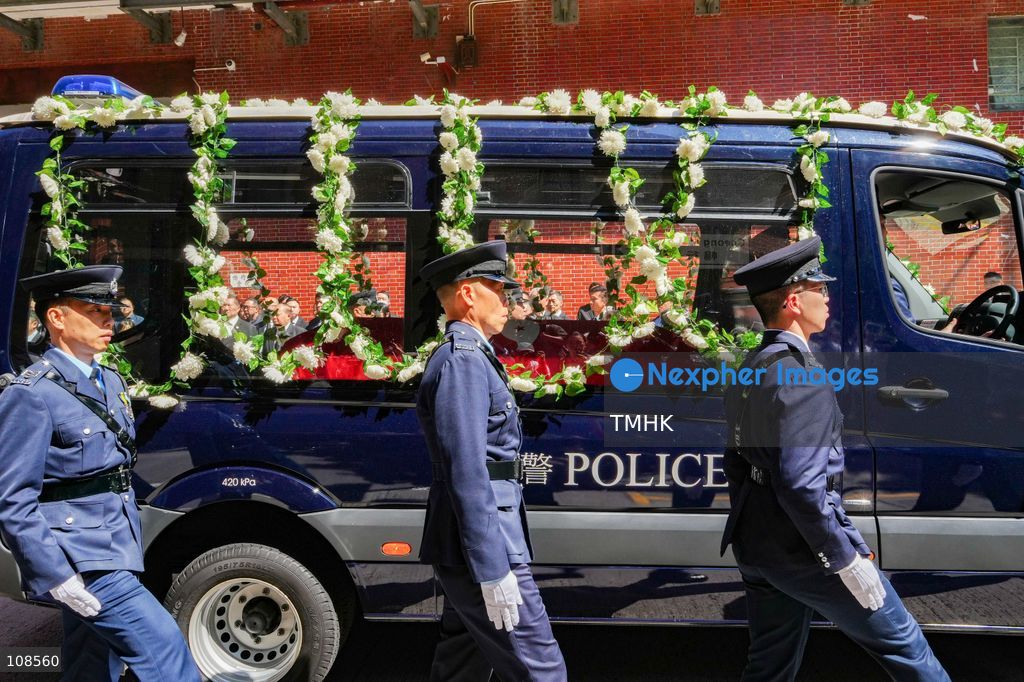 The coffin of late police officer Chu Chun-kwok, draped with the Hong Kong regional flag, is seen inside a hearse departing the Universal Funeral Parlour in Hung Hom, Hong Kong, on October 23, 2026, following a funeral with full police honours. (Photo by Zulu Lo/TMHK via Nexpher Images)