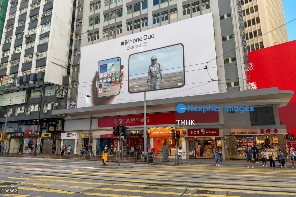 A large advertisement promoting Apple's first foldable smartphone, the iPhone Duo, is displayed along Hennessy Road in Causeway Bay, Hong Kong, on October 23, 2026, the device's official launch day. (Photo by Kevin Li/TMHK via Nexpher Images)