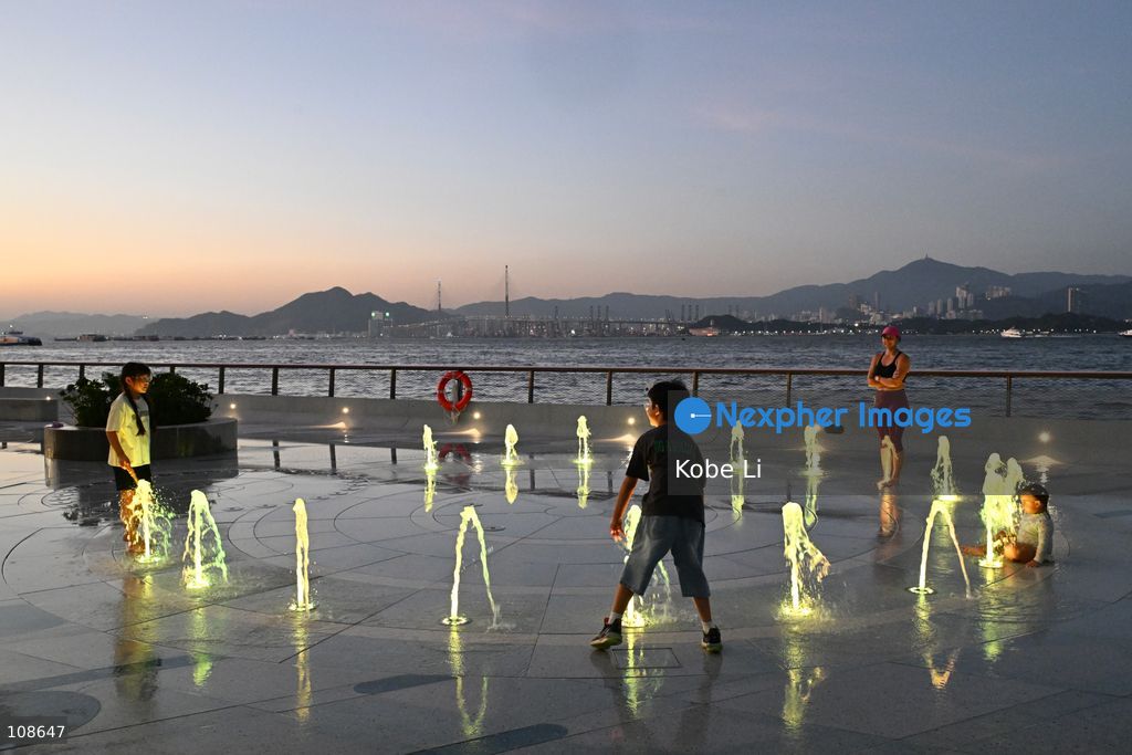 People playing at artificial fountain of waterfront near the Victoria Harbour on October 23, 2026 in Hong Kong. (Photo by Kobe Li/Nexpher Images)