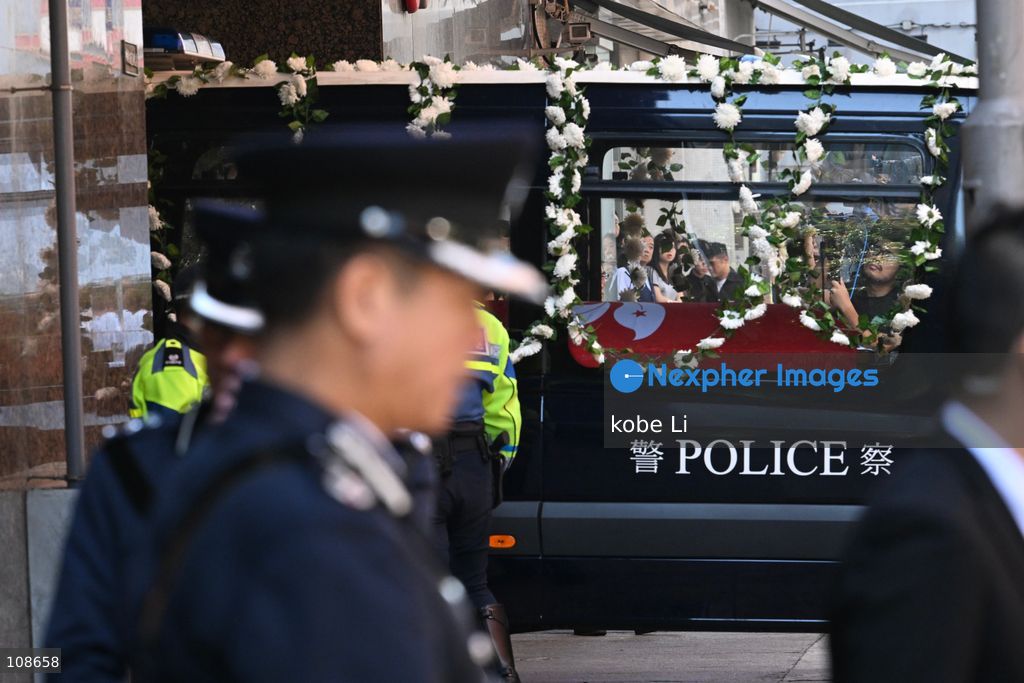 The coffin of late police officer Chu Chun-kwok, draped with the Hong Kong regional flag, is seen inside a hearse departing the Universal Funeral Parlour in Hung Hom on October 23, 2026 in Hong Kong (Photo by kobe Li/Nexpher Images)