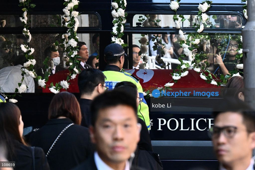 The coffin of late police officer Chu Chun-kwok, draped with the Hong Kong regional flag, is seen inside a hearse departing the Universal Funeral Parlour in Hung Hom on October 23, 2026 in Hong Kong (Photo by kobe Li/Nexpher Images)