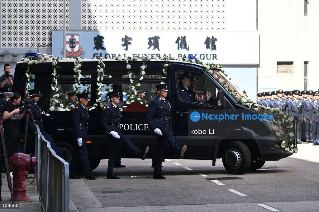 The coffin of late police officer Chu Chun-kwok, draped with the Hong Kong regional flag, is seen inside a hearse departing the Universal Funeral Parlour in Hung Hom on October 23, 2026 in Hong Kong (Photo by kobe Li/Nexpher Images)