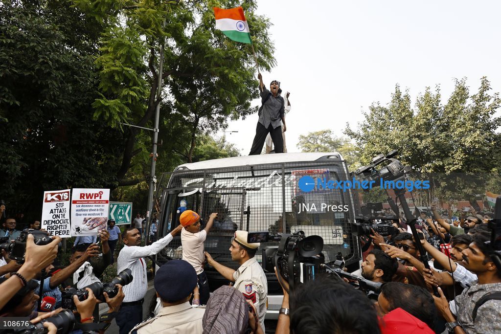 NEW DELHI, INDIA, OCTOBER 23, 2026: Police personnel detain an activist near Bangla Sahib Gurdwara during a protest demanding the resignation of Chief Election Commissioner Gyanesh Kumar. Members of student and civil society organisations attempt to march towards the Election Commission’s headquarters, opposing the Special Intensive Revision (SIR) of electoral rolls. (Photo by Vishal Kapoor/JNA Press via Nexpher Images)