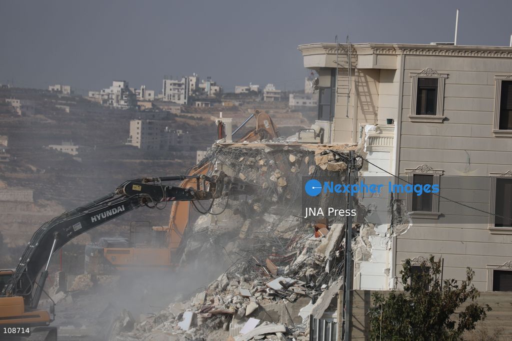 HEBRON, PALESTINE, OCTOBER 23, 2026: Israeli forces demolish a Palestinian residential building in the Farsh al-Hawa area of Hebron in the occupied West Bank. The demolition follows a shooting attack at a nearby military checkpoint earlier in the day and Israeli orders targeting buildings around the attack site. (Photo by Mosab shawer/JNA Press via Nexpher Images)