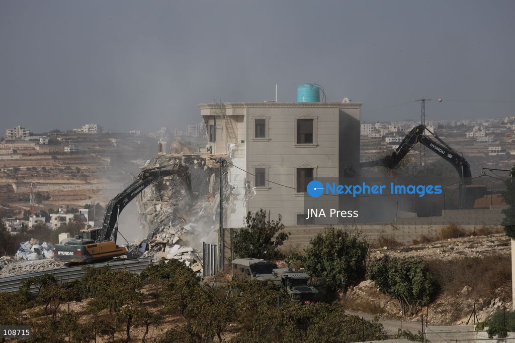 HEBRON, PALESTINE, OCTOBER 23, 2026: Israeli forces demolish a Palestinian residential building in the Farsh al-Hawa area of Hebron in the occupied West Bank. The demolition follows a shooting attack at a nearby military checkpoint earlier in the day and Israeli orders targeting buildings around the attack site. (Photo by Mosab shawer/JNA Press via Nexpher Images)