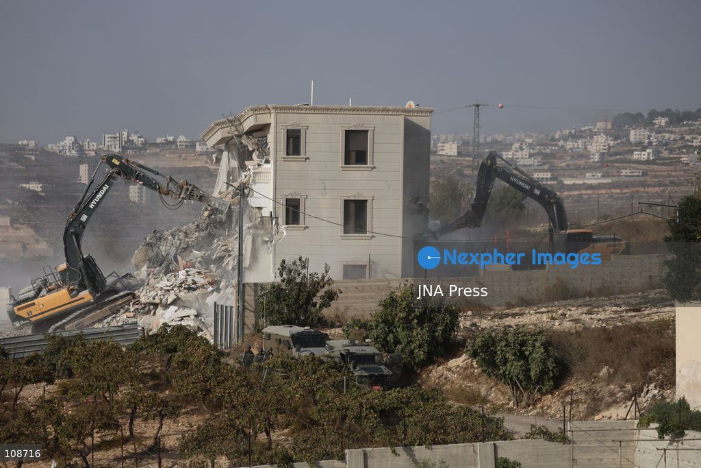 HEBRON, PALESTINE, OCTOBER 23, 2026: Israeli forces demolish a Palestinian residential building in the Farsh al-Hawa area of Hebron in the occupied West Bank. The demolition follows a shooting attack at a nearby military checkpoint earlier in the day and Israeli orders targeting buildings around the attack site. (Photo by Mosab shawer/JNA Press via Nexpher Images)