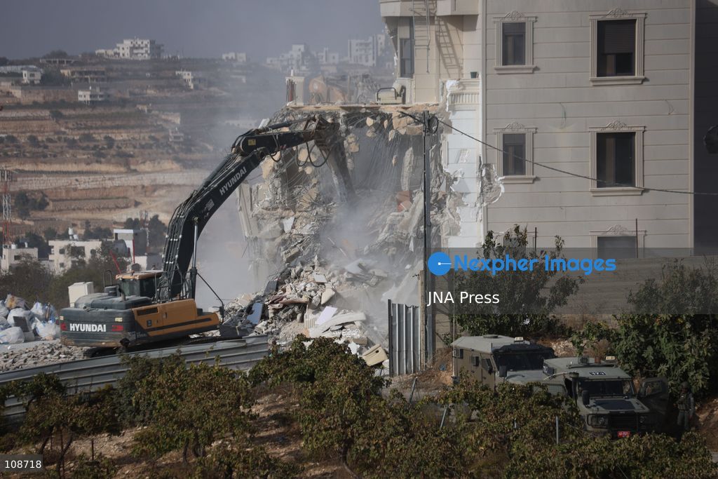 HEBRON, PALESTINE, OCTOBER 23, 2026: Israeli forces demolish a Palestinian residential building in the Farsh al-Hawa area of Hebron in the occupied West Bank. The demolition follows a shooting attack at a nearby military checkpoint earlier in the day and Israeli orders targeting buildings around the attack site. (Photo by Mosab shawer/JNA Press via Nexpher Images)