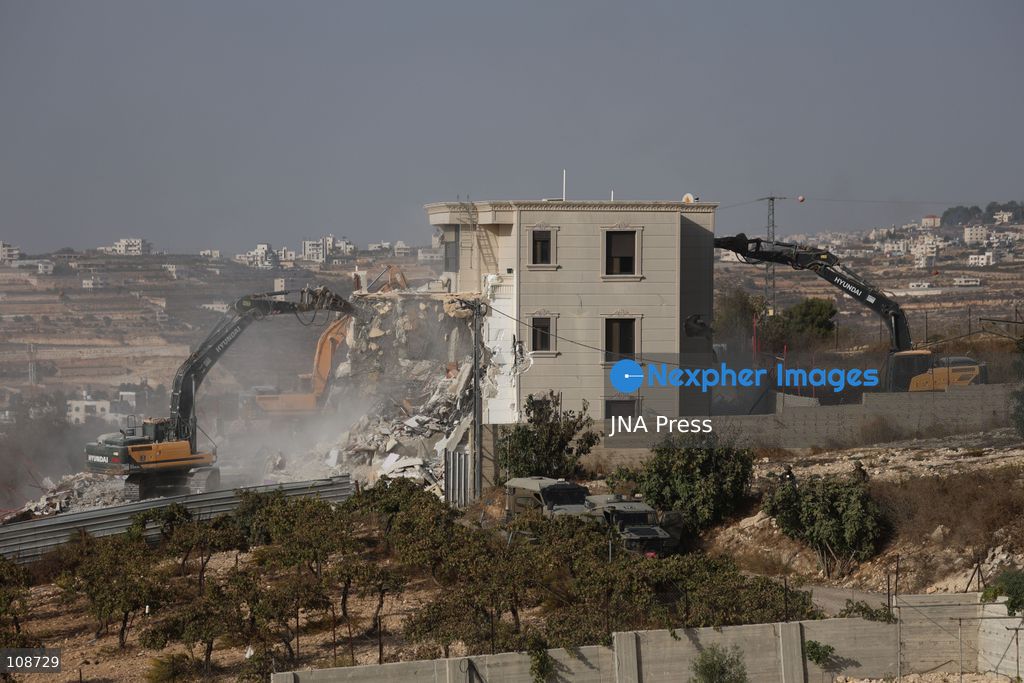 HEBRON, PALESTINE, OCTOBER 23, 2026: Israeli forces demolish a Palestinian residential building in the Farsh al-Hawa area of Hebron in the occupied West Bank. The demolition follows a shooting attack at a nearby military checkpoint earlier in the day and Israeli orders targeting buildings around the attack site. (Photo by Mosab shawer/JNA Press via Nexpher Images)