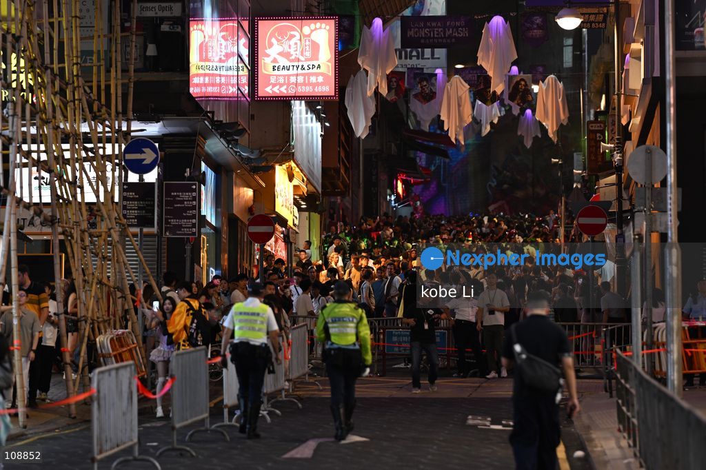 Hong Kong police implemented crowd control measures during visitors visiting at Lan Kwai Fong in Central on the eve of Halloween on October 24, 2026 in Hong Kong. (Photo by kobe Li/Nexpher Images)