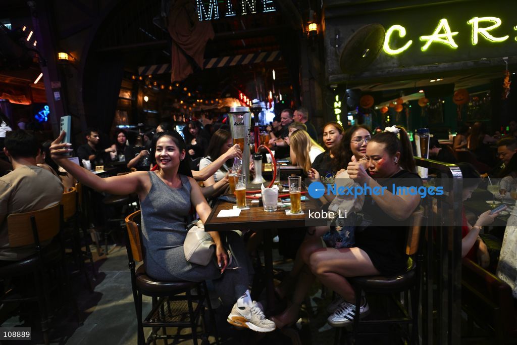 Visitors posing photo at a bar of Lan Kwai Fong in Central on the eve of Halloween on October 24, 2026 in Hong Kong. (Photo by kobe Li/Nexpher Images)