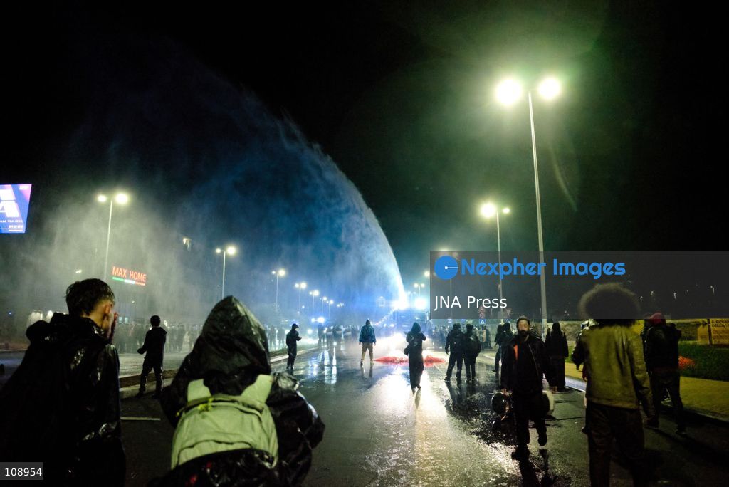 TURIN, ITALY, OCTOBER 24, 2026: Riot police use water cannons and tear gas during confrontations with demonstrators protesting against military rearmament, rising living costs and government policies in Turin. The march begins in Piazza Castello before moving towards northern districts, with clashes occurring as police block protesters from entering streets leading towards the city centre. (Photo by Chiara Antenucci/JNA Press via Nexpher Images)