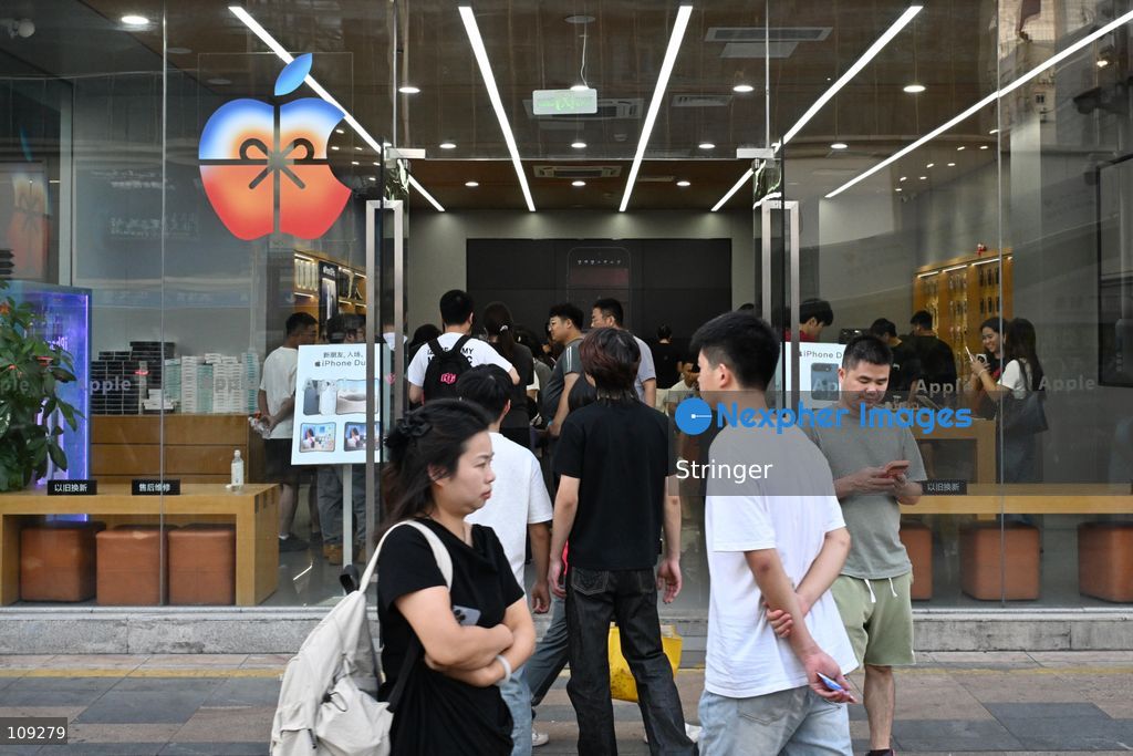 Visitors walking outside a Apple store on October 25, 2026 in Shenzhen, China. (Photo by Stringer/Nexpher Images)