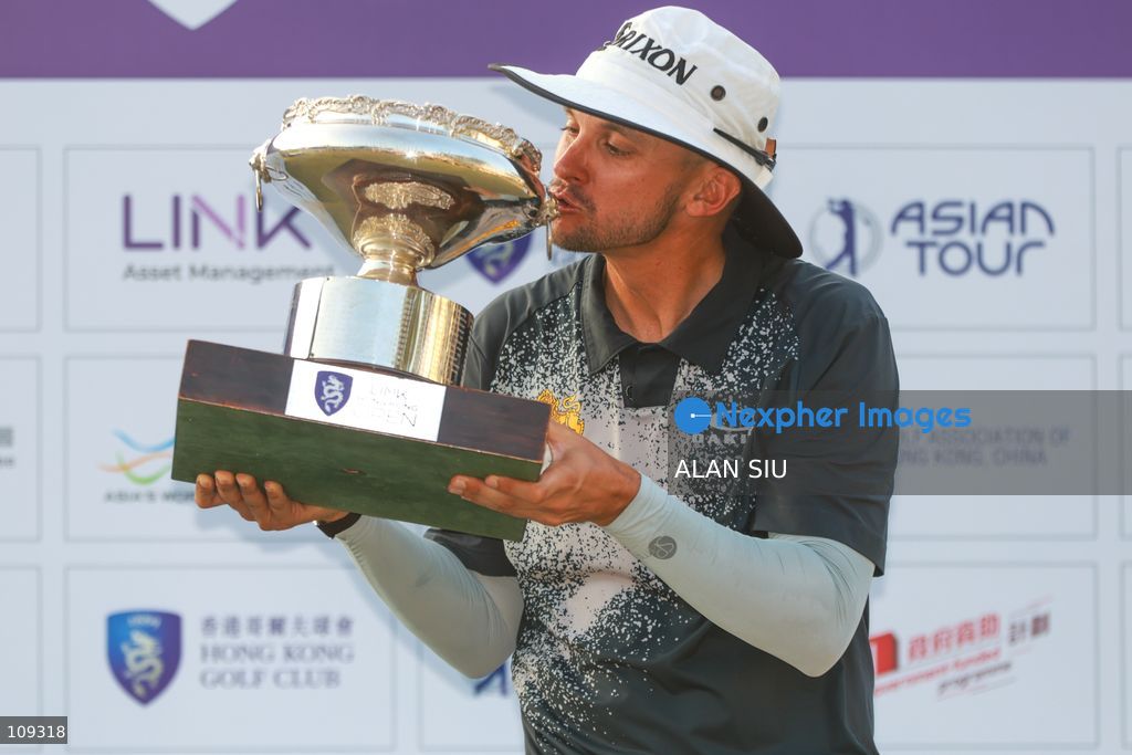 John Catlin of USA kisses the trophy after winning The Link Hong Kong Open at the Hong Kong Golf Club in Faning on October 25, 2026 in Hong Kong. (Photo by ALAN SIU/Nexpher Images)