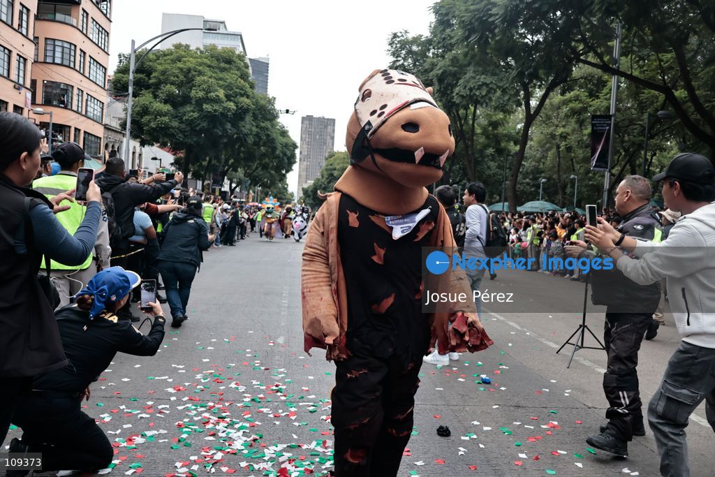 Mascots in various character and animal forms begin to reach the finish line during the second edition of the Mascot Race on October 24, 2026, in Mexico City, Mexico. The Mexico City Secretariat of Citizen Security held its second annual Mascot Race, which took place as part of the Day of the Dead festivities. The 52 competitors wore oversized costumes to race along one of the city’s main avenues, delighting the attendees who enjoyed watching these mascots dash toward victory. (Photo by Josue Pérez/Nexpher Images)