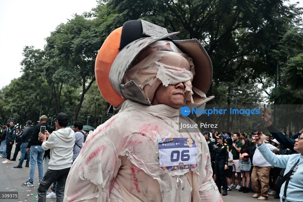 Mascots in various character and animal forms begin to reach the finish line during the second edition of the Mascot Race on October 24, 2026, in Mexico City, Mexico. The Mexico City Secretariat of Citizen Security held its second annual Mascot Race, which took place as part of the Day of the Dead festivities. The 52 competitors wore oversized costumes to race along one of the city’s main avenues, delighting the attendees who enjoyed watching these mascots dash toward victory. (Photo by Josue Pérez/Nexpher Images)