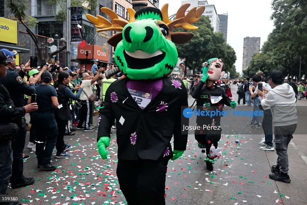 Mascots in various character and animal forms begin to reach the finish line during the second edition of the Mascot Race on October 24, 2026, in Mexico City, Mexico. The Mexico City Secretariat of Citizen Security held its second annual Mascot Race, which took place as part of the Day of the Dead festivities. The 52 competitors wore oversized costumes to race along one of the city’s main avenues, delighting the attendees who enjoyed watching these mascots dash toward victory. (Photo by Josue Pérez/Nexpher Images)