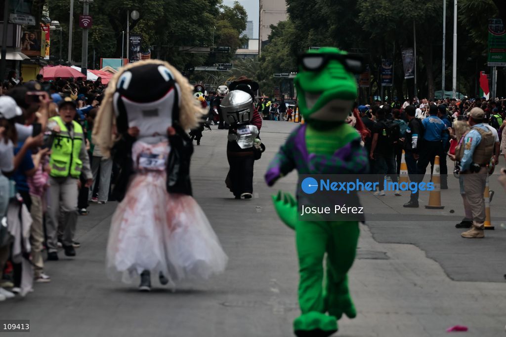 Mascots in various character and animal forms begin to reach the finish line during the second edition of the Mascot Race on October 24, 2026, in Mexico City, Mexico. The Mexico City Secretariat of Citizen Security held its second annual Mascot Race, which took place as part of the Day of the Dead festivities. The 52 competitors wore oversized costumes to race along one of the city’s main avenues, delighting the attendees who enjoyed watching these mascots dash toward victory. (Photo by Josue Pérez/Nexpher Images)