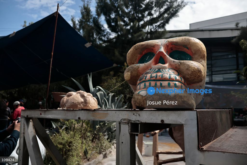 Pieces of the parade float for the Day of the Dead parade are being placed in various locations to keep them organized, on October 24, 2026, in Mexico City, Mexico. At the Arts and Trades Factory of the East (FARO de Oriente), located in the Iztapalapa district, one of the floats for the Day of the Dead parade is being constructed. Titled "Panadero con el pan" ("Baker with the Bread"), the float is being built by artisans who specialize in alebrijes (fantastical creatures) and cartonería (traditional papier-mache/cardboard craft). They are crafting skulls, calaveras (stylized skeletal figures), and pan de muerto (traditional Day of the Dead bread) to assemble the float, which will also feature cempasúchil (marigold) flowers. (Photo by Josue Pérez/Nexpher Images)