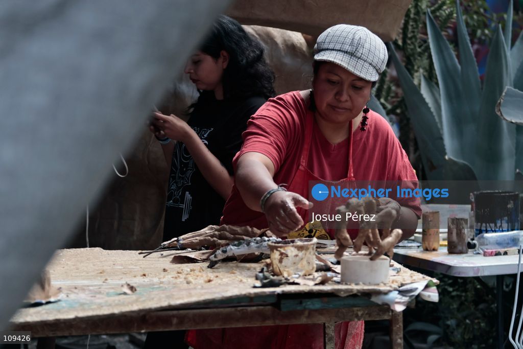 Pieces of the parade float for the Day of the Dead parade are being placed in various locations to keep them organized, on October 24, 2026, in Mexico City, Mexico. At the Arts and Trades Factory of the East (FARO de Oriente), located in the Iztapalapa district, one of the floats for the Day of the Dead parade is being constructed. Titled "Panadero con el pan" ("Baker with the Bread"), the float is being built by artisans who specialize in alebrijes (fantastical creatures) and cartonería (traditional papier-mache/cardboard craft). They are crafting skulls, calaveras (stylized skeletal figures), and pan de muerto (traditional Day of the Dead bread) to assemble the float, which will also feature cempasúchil (marigold) flowers. (Photo by Josue Pérez/Nexpher Images)
