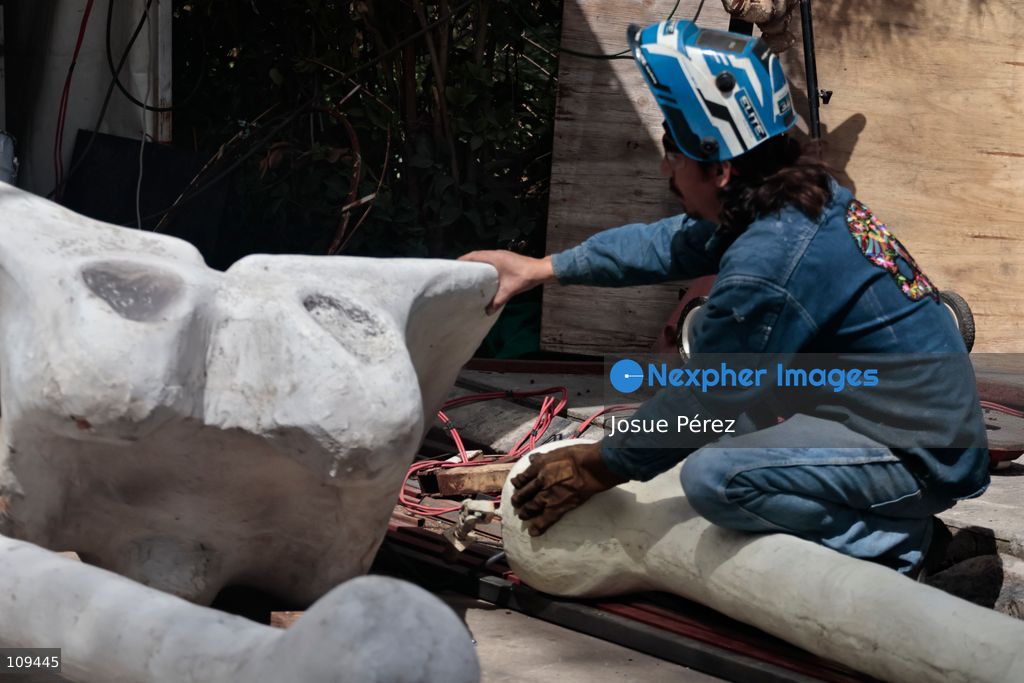 Pieces of the parade float for the Day of the Dead parade are being placed in various locations to keep them organized, on October 24, 2026, in Mexico City, Mexico. At the Arts and Trades Factory of the East (FARO de Oriente), located in the Iztapalapa district, one of the floats for the Day of the Dead parade is being constructed. Titled "Panadero con el pan" ("Baker with the Bread"), the float is being built by artisans who specialize in alebrijes (fantastical creatures) and cartonería (traditional papier-mache/cardboard craft). They are crafting skulls, calaveras (stylized skeletal figures), and pan de muerto (traditional Day of the Dead bread) to assemble the float, which will also feature cempasúchil (marigold) flowers. (Photo by Josue Pérez/Nexpher Images)