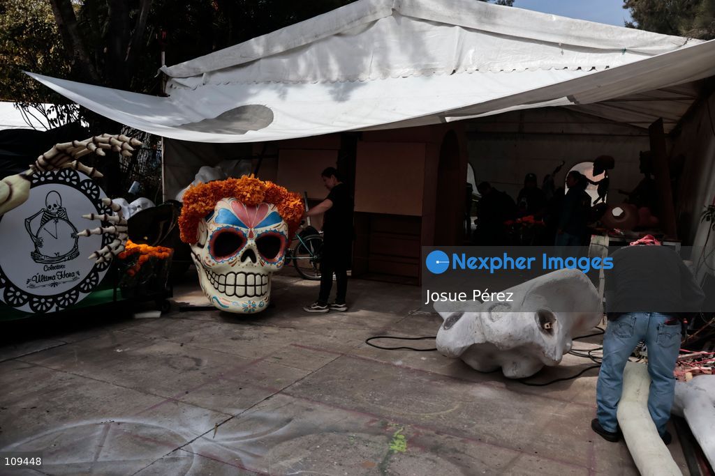 Pieces of the parade float for the Day of the Dead parade are being placed in various locations to keep them organized, on October 24, 2026, in Mexico City, Mexico. At the Arts and Trades Factory of the East (FARO de Oriente), located in the Iztapalapa district, one of the floats for the Day of the Dead parade is being constructed. Titled "Panadero con el pan" ("Baker with the Bread"), the float is being built by artisans who specialize in alebrijes (fantastical creatures) and cartonería (traditional papier-mache/cardboard craft). They are crafting skulls, calaveras (stylized skeletal figures), and pan de muerto (traditional Day of the Dead bread) to assemble the float, which will also feature cempasúchil (marigold) flowers. (Photo by Josue Pérez/Nexpher Images)