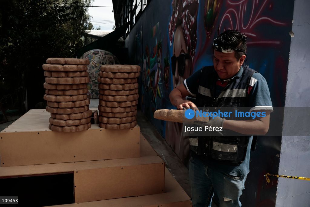 Pieces of the parade float for the Day of the Dead parade are being placed in various locations to keep them organized, on October 24, 2026, in Mexico City, Mexico. At the Arts and Trades Factory of the East (FARO de Oriente), located in the Iztapalapa district, one of the floats for the Day of the Dead parade is being constructed. Titled "Panadero con el pan" ("Baker with the Bread"), the float is being built by artisans who specialize in alebrijes (fantastical creatures) and cartonería (traditional papier-mache/cardboard craft). They are crafting skulls, calaveras (stylized skeletal figures), and pan de muerto (traditional Day of the Dead bread) to assemble the float, which will also feature cempasúchil (marigold) flowers. (Photo by Josue Pérez/Nexpher Images)