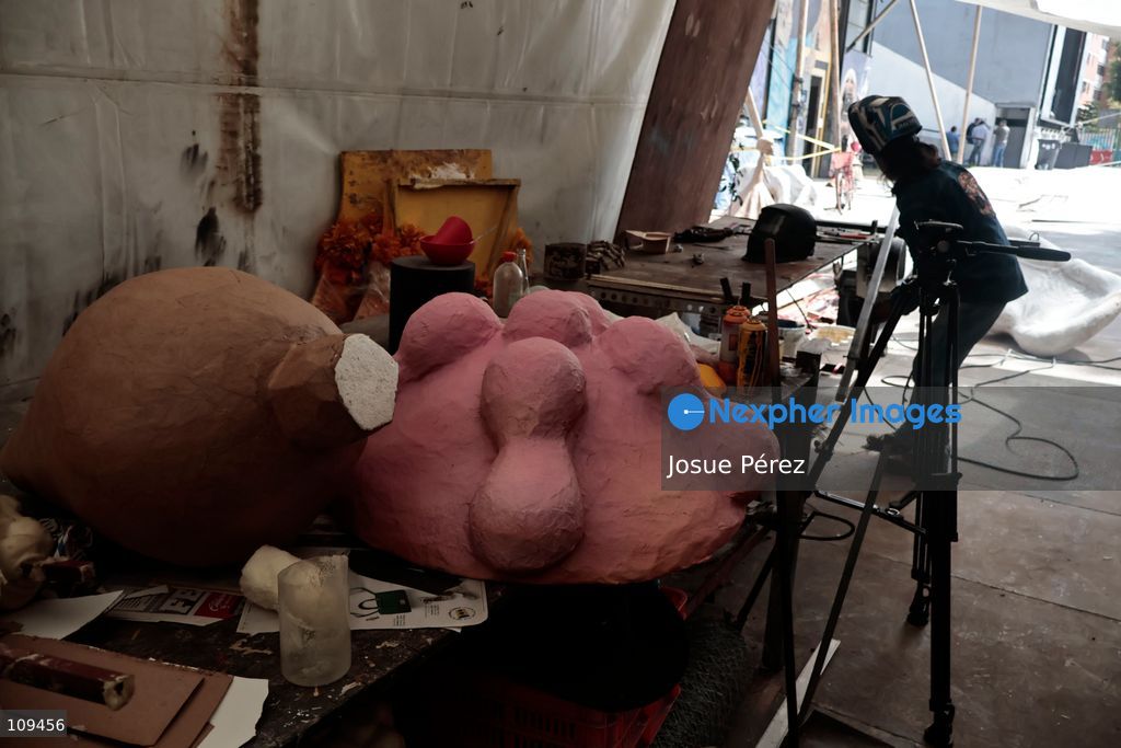 Pieces of the parade float for the Day of the Dead parade are being placed in various locations to keep them organized, on October 24, 2026, in Mexico City, Mexico. At the Arts and Trades Factory of the East (FARO de Oriente), located in the Iztapalapa district, one of the floats for the Day of the Dead parade is being constructed. Titled "Panadero con el pan" ("Baker with the Bread"), the float is being built by artisans who specialize in alebrijes (fantastical creatures) and cartonería (traditional papier-mache/cardboard craft). They are crafting skulls, calaveras (stylized skeletal figures), and pan de muerto (traditional Day of the Dead bread) to assemble the float, which will also feature cempasúchil (marigold) flowers. (Photo by Josue Pérez/Nexpher Images)