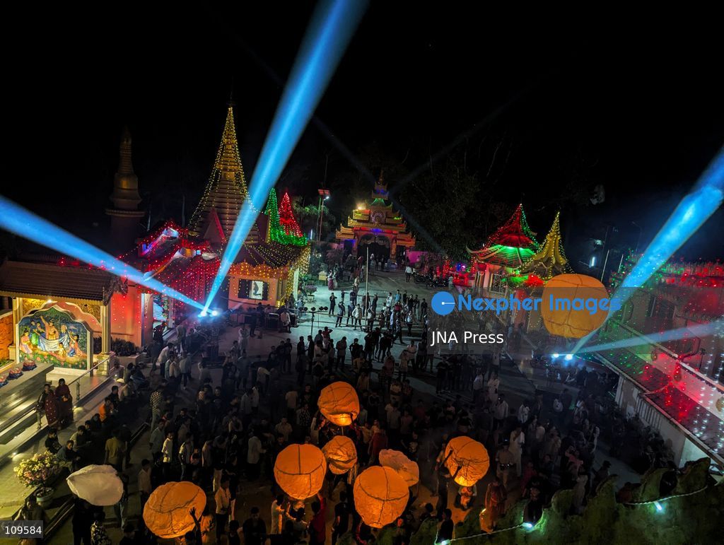 CHITTAGONG, BANGLADESH - OCTOBER 25, 2026: Devotees gather at a Buddhist temple during Prabarana Purnima celebrations, as colourful lights illuminate the temple grounds and illuminated lanterns rise into the night sky. The festival marks an important occasion in the Buddhist calendar, bringing communities together through religious traditions and cultural celebrations. (Photo by Sumon Das/JNA Press via Nexpher Images)
