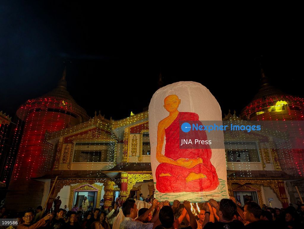 CHITTAGONG, BANGLADESH - OCTOBER 25, 2026: Devotees gather at a Buddhist temple during Prabarana Purnima celebrations, as colourful lights illuminate the temple grounds and illuminated lanterns rise into the night sky. The festival marks an important occasion in the Buddhist calendar, bringing communities together through religious traditions and cultural celebrations. (Photo by Sumon Das/JNA Press via Nexpher Images)