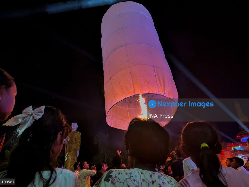 CHITTAGONG, BANGLADESH - OCTOBER 25, 2026: Devotees gather at a Buddhist temple during Prabarana Purnima celebrations, as colourful lights illuminate the temple grounds and illuminated lanterns rise into the night sky. The festival marks an important occasion in the Buddhist calendar, bringing communities together through religious traditions and cultural celebrations. (Photo by Sumon Das/JNA Press via Nexpher Images)