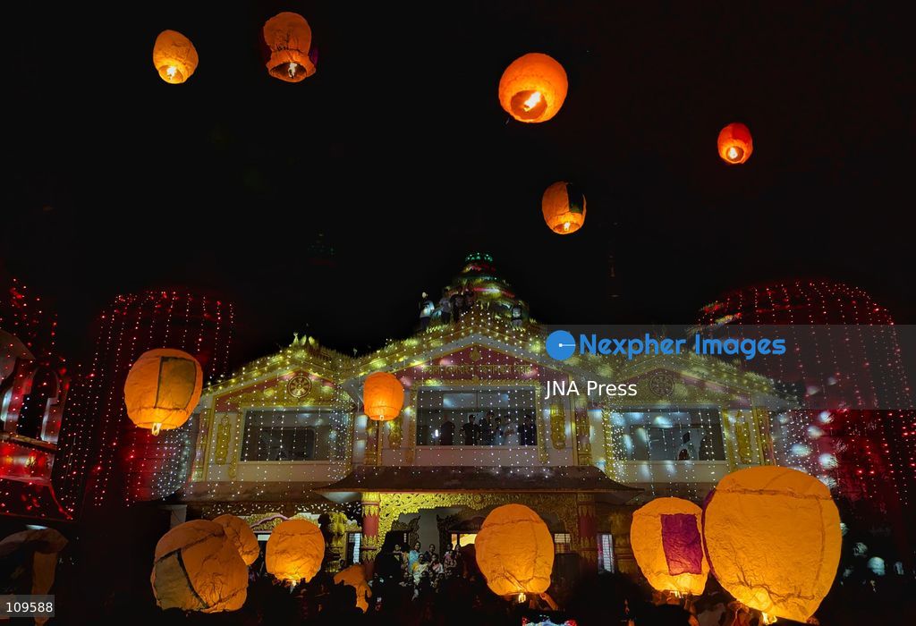 CHITTAGONG, BANGLADESH - OCTOBER 25, 2026: Devotees gather at a Buddhist temple during Prabarana Purnima celebrations, as colourful lights illuminate the temple grounds and illuminated lanterns rise into the night sky. The festival marks an important occasion in the Buddhist calendar, bringing communities together through religious traditions and cultural celebrations. (Photo by Sumon Das/JNA Press via Nexpher Images)